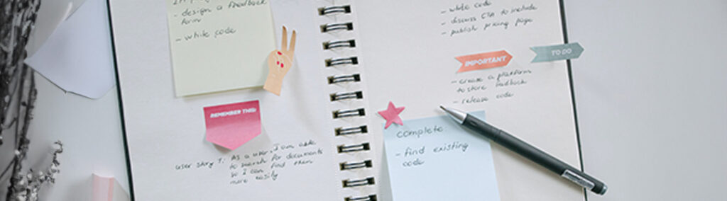 A notebook open with sticky notes and writing, planning consistency across platforms.