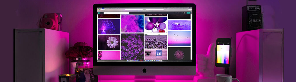 A monitor screen with different purple aesthetic photos that are being selected for website design.